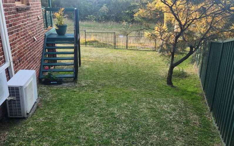 A freshly mown backyard lawn after a Coasties garden visit