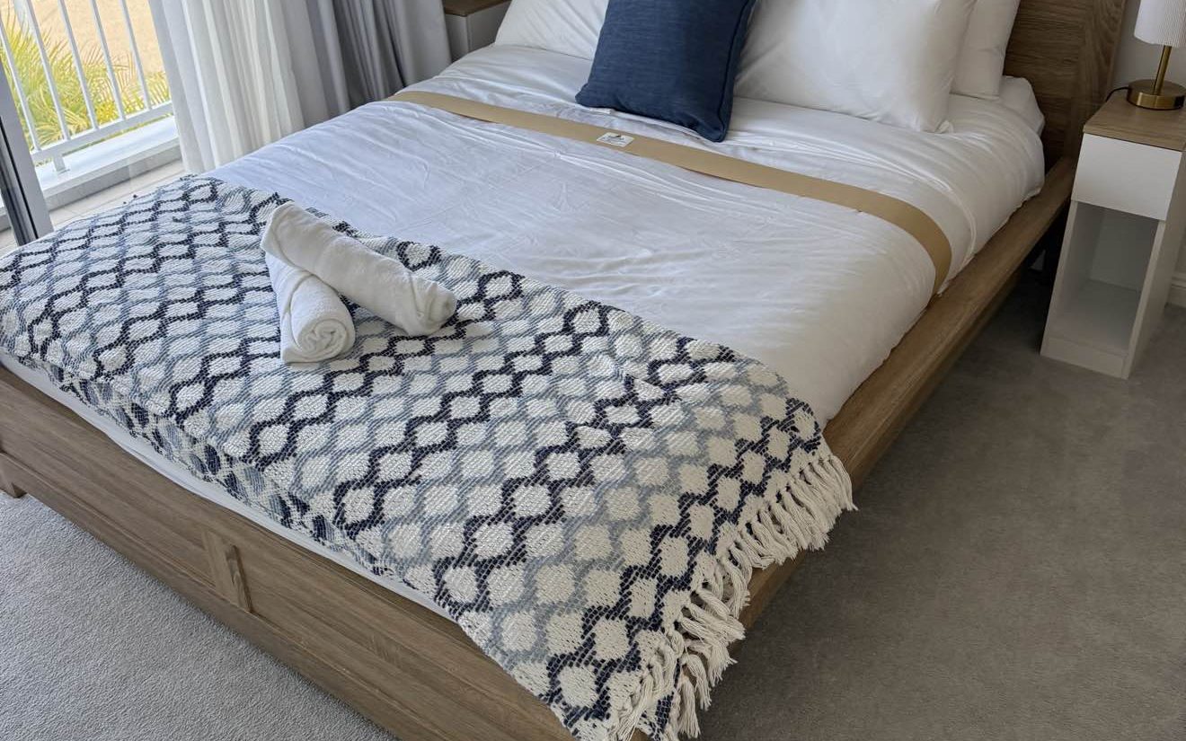 A holiday rental bedroom made up by Coasties with fresh linen and towels