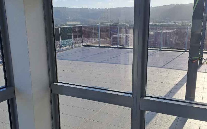 A strata rooftop terrace and glass doors cleaned by Coasties in Gosford